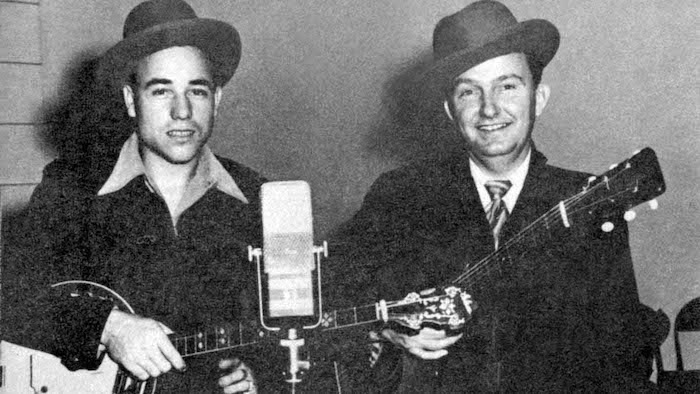 Earl Scruggs (left) and Lester Flatt pose with their instruments